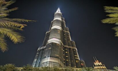 a tall burj khalifa building with lights at night