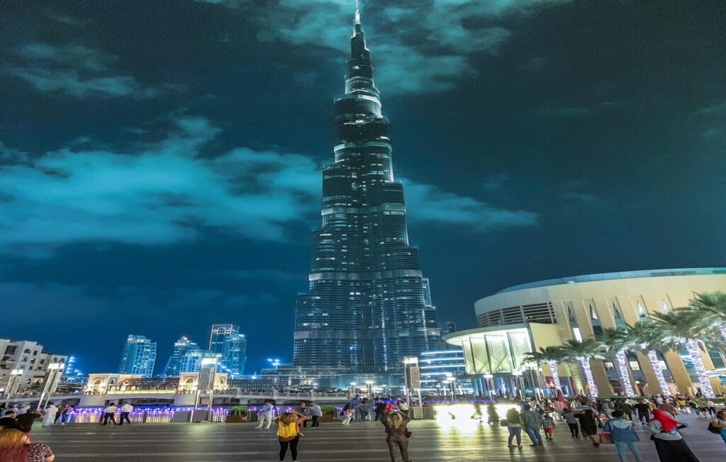 a large burj khalifa building with a pointy top in dark night