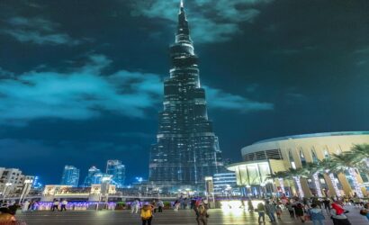 a large burj khalifa building with a pointy top in dark night