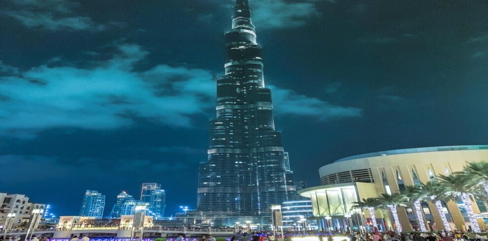 a large burj khalifa building with a pointy top in dark night