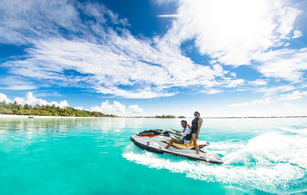 a couple on a jet ski in the water